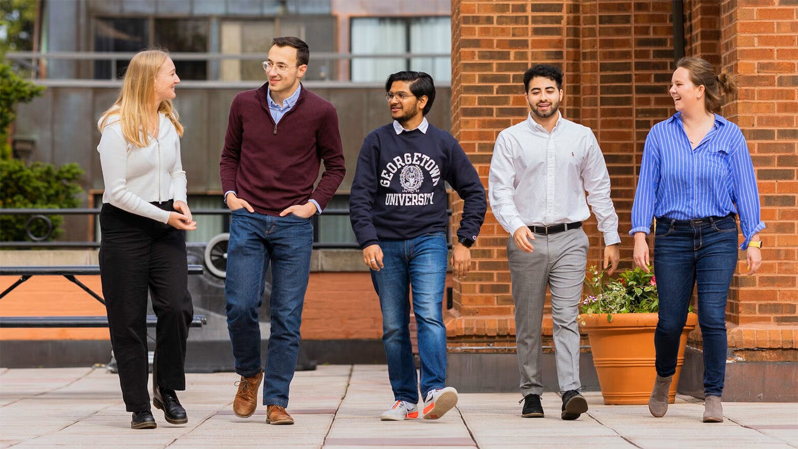 five students walking on campus