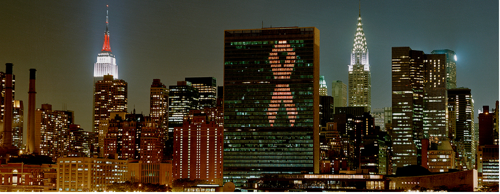 New York City skyline at night with HIV ribbon projected onto building